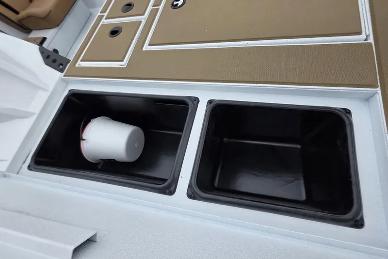 Slide: The Image of 2026 Xpress H20CC boat storage compartments with a white bucket inside. - 20