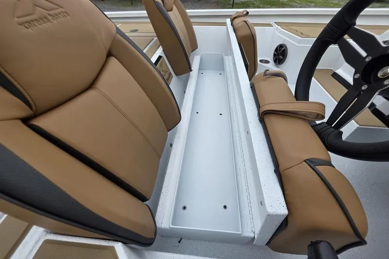Slide: The Image of 2026 Xpress H20CC boat interior with tan seats and steering wheel. - 21
