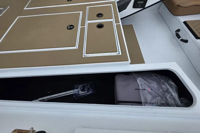 Slide: The Image of 2026 Xpress H20CC boat interior with storage compartments and equipment. - 23