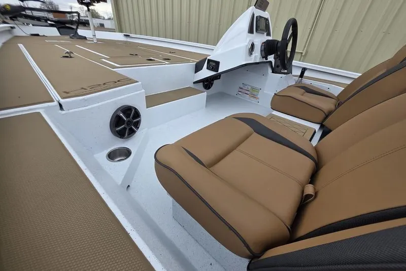 Slide: The Image of 2026 Xpress H20CC boat interior with tan seats and modern dashboard design. - 24