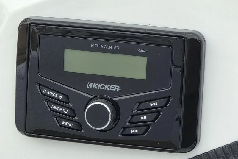 Slide: The Image of Kicker media center on 2026 Xpress H20CC boat dashboard, featuring control buttons and display. - 28