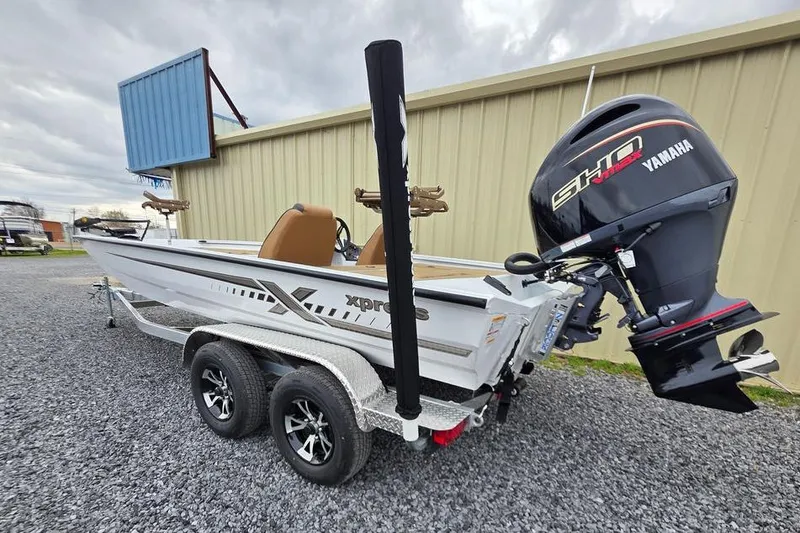 Slide: The Image of 2026 Xpress H20CC boat with Yamaha engine on trailer, parked outdoors. - 6