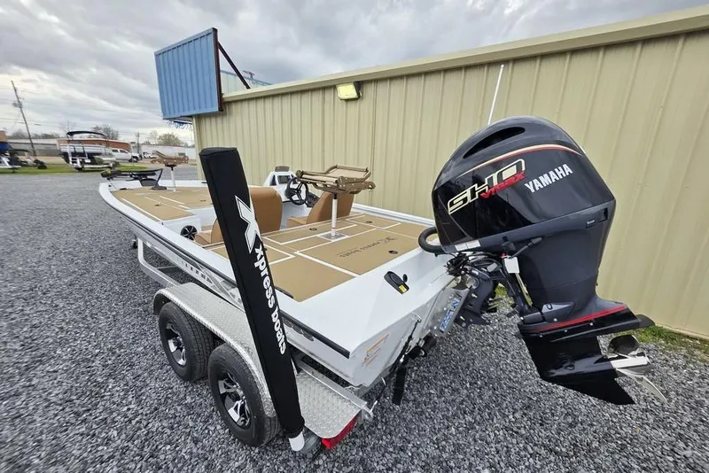Slide: The Image of 2026 Xpress H20CC boat with Yamaha engine on trailer, parked outdoors. - 7