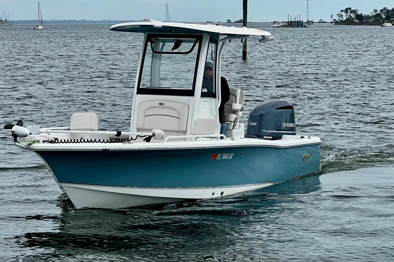 Slide: The Image of 2021 Sea Hunt BX 25 FS boat cruising on calm waters. - 11