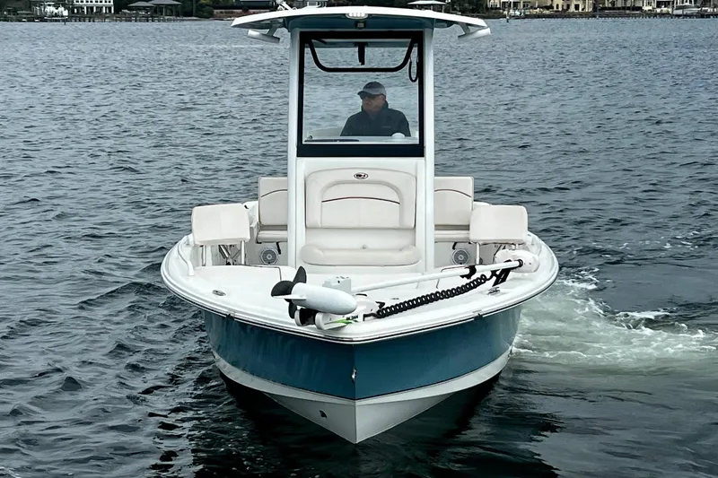 Slide: The Image of 2021 Sea Hunt BX 25 FS boat cruising on open water. - 12