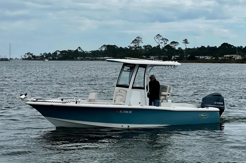 Slide: The Image of 2021 Sea Hunt BX 25 FS boat on water with Yamaha engine, overcast sky. - 15