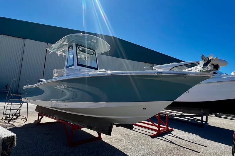 Slide: The Image of 2021 Sea Hunt BX 25 FS boat on display under clear blue sky. - 18