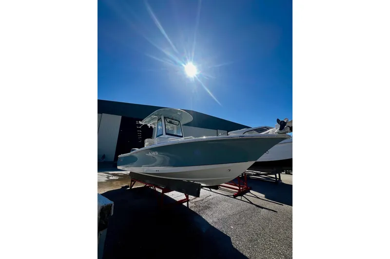 Slide: The Image of 2021 Sea Hunt BX 25 FS boat under bright sun in a marina setting. - 22