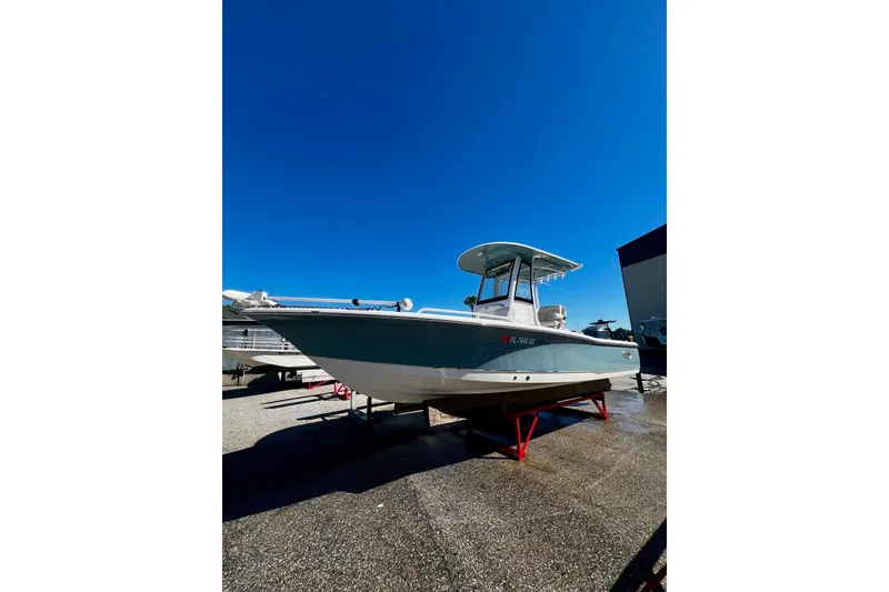 Slide: The Image of 2021 Sea Hunt BX 25 FS boat on display under clear blue sky. - 23
