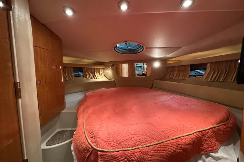 Slide: The Image of Luxurious cabin interior of 2004 Regal Commodore 3860 yacht with cozy bed and ambient lighting. - 17