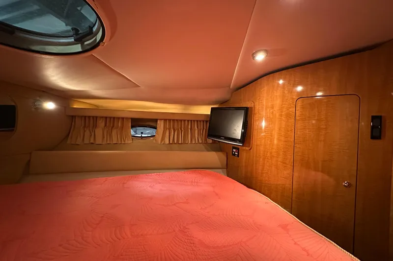 Slide: The Image of Luxurious cabin interior of 2004 Regal Commodore 3860 yacht with wood paneling and TV. - 18