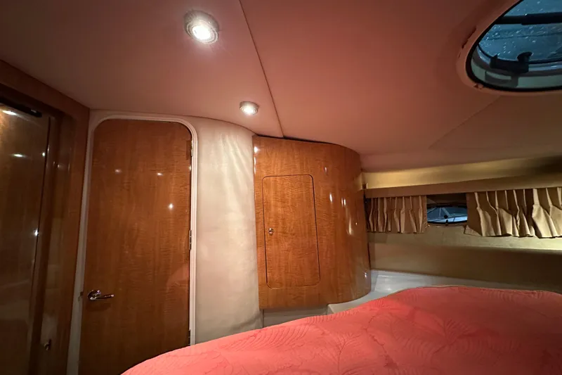 Slide: The Image of Luxurious cabin interior of 2004 Regal Commodore 3860 yacht with wood paneling and cozy lighting. - 19