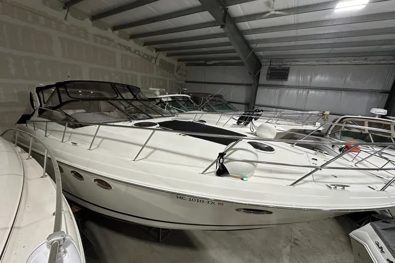 Slide: The Image of 2004 Regal Commodore 3860 yacht in indoor storage, showcasing sleek design and modern features. - 2