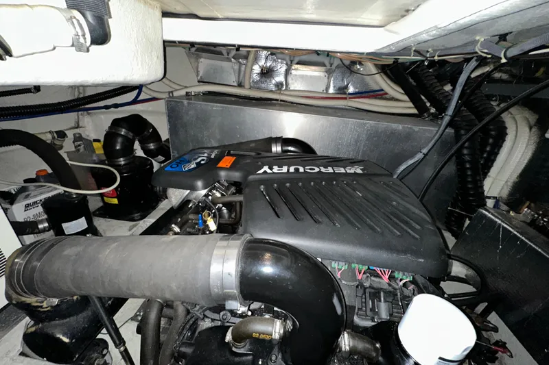 Slide: The Image of Engine compartment of 2004 Regal Commodore 3860 with Mercury engine components. - 29