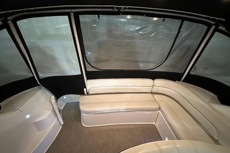Slide: The Image of 2004 Regal Commodore 3860 yacht interior with beige seating and enclosed canopy. - 6