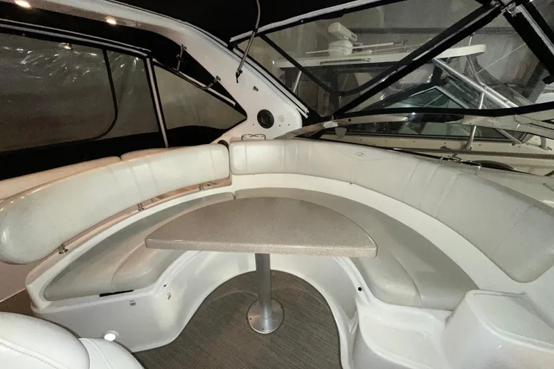 Slide: The Image of 2004 Regal Commodore 3860 boat interior with curved seating and table. - 8