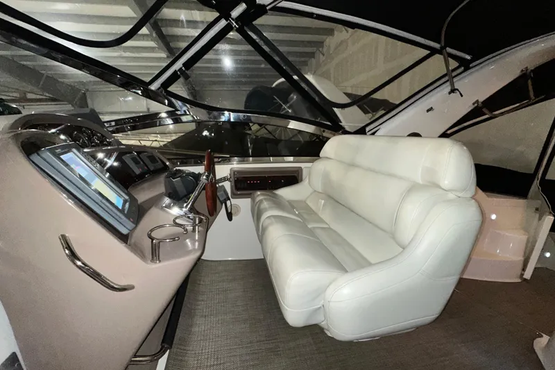 Slide: The Image of Interior of 2004 Regal Commodore 3860 yacht with plush seating and modern controls. - 9
