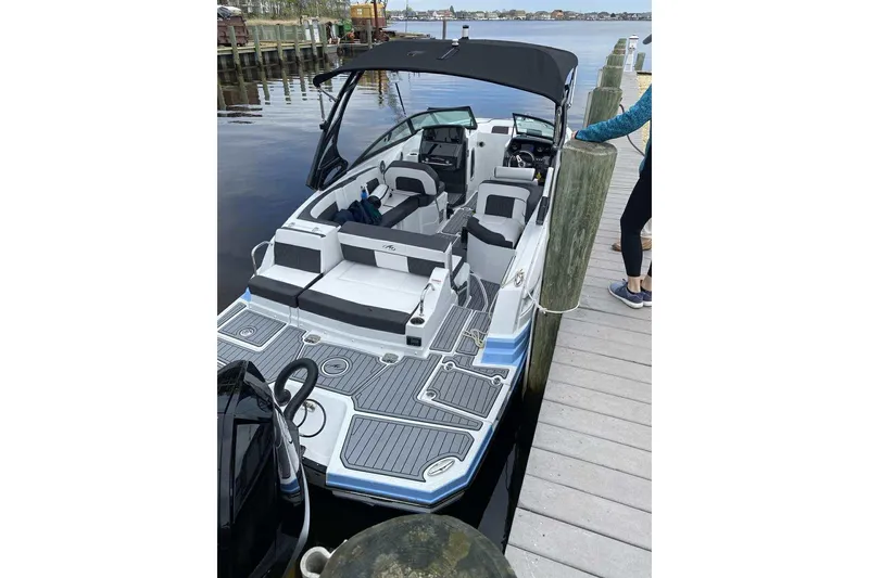 The Image of 2021 Monterey Boats M65 docked, featuring spacious seating and sleek design. - 1