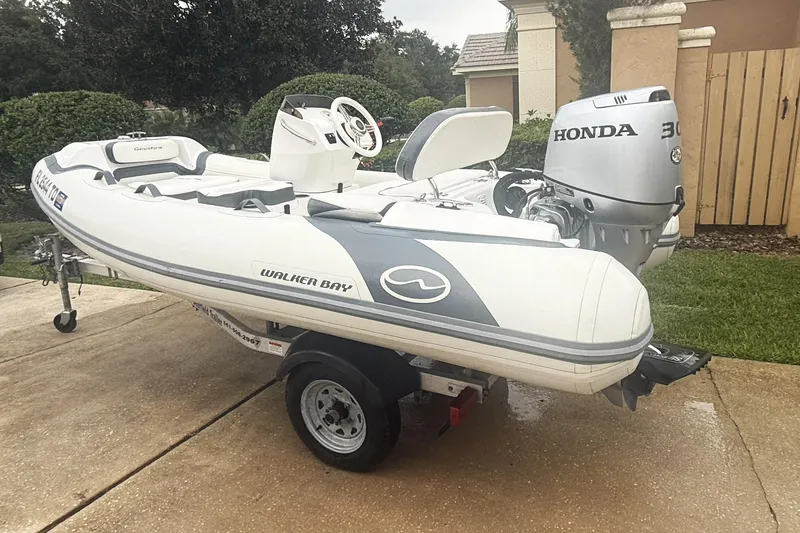 Slide: The Image of 2022 Walker Bay Generation 11 LTE boat with Honda 30 engine on a trailer. - 2