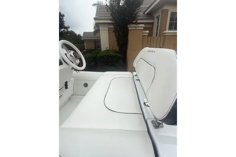 Slide: The Image of 2022 Walker Bay Generation 11 LTE boat interior with white seating and steering wheel. - 4