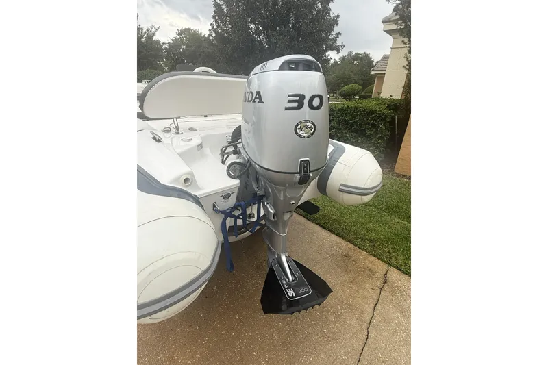 Slide: The Image of 2022 Walker Bay Generation 11 LTE with Honda 30 outboard motor on driveway. - 5