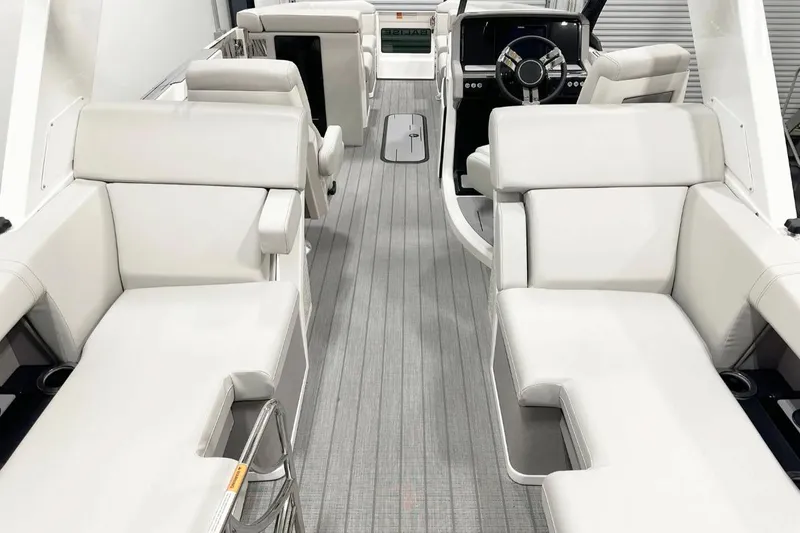 Slide: The Image of Luxurious interior of 2025 Balise Helix 24C boat with plush white seating. - 10