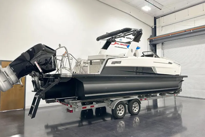Slide: The Image of 2025 Balise Helix 24C boat on trailer in indoor showroom. - 3