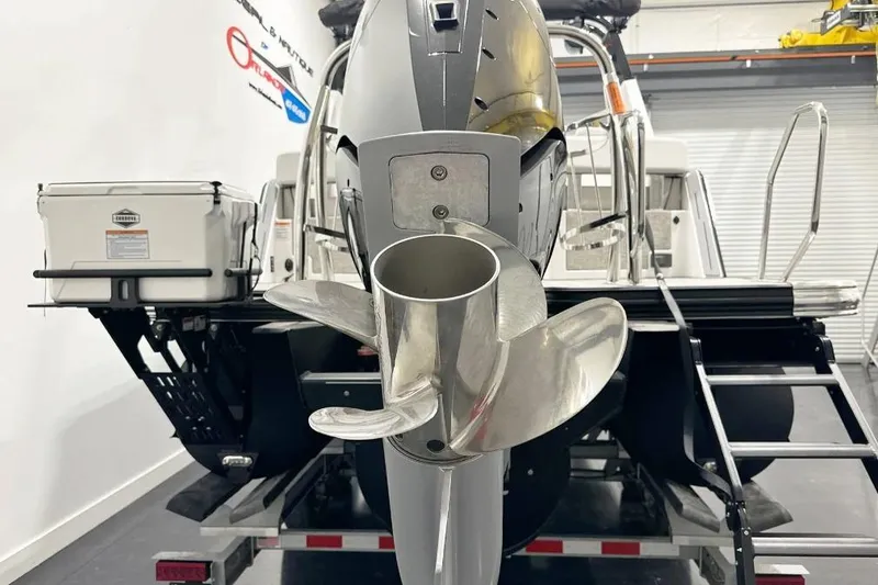 Slide: The Image of Rear view of a 2025 Balise Helix 24C boat with a shiny propeller. - 4