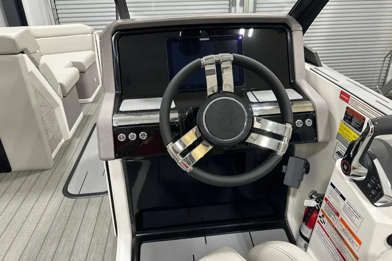 Slide: The Image of Helix 24C 2025 boat dashboard with steering wheel and control panel. - 5