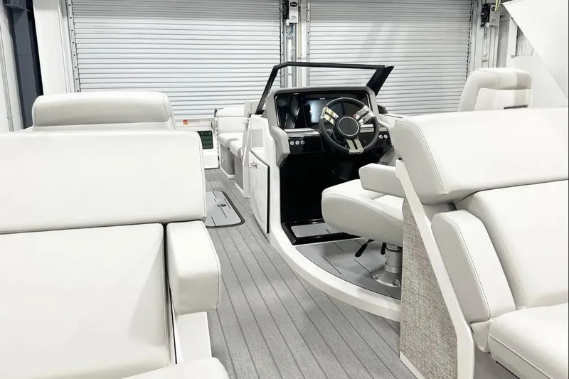 Slide: The Image of Luxurious interior of 2025 Balise Helix 24C boat with plush white seating and modern steering. - 9