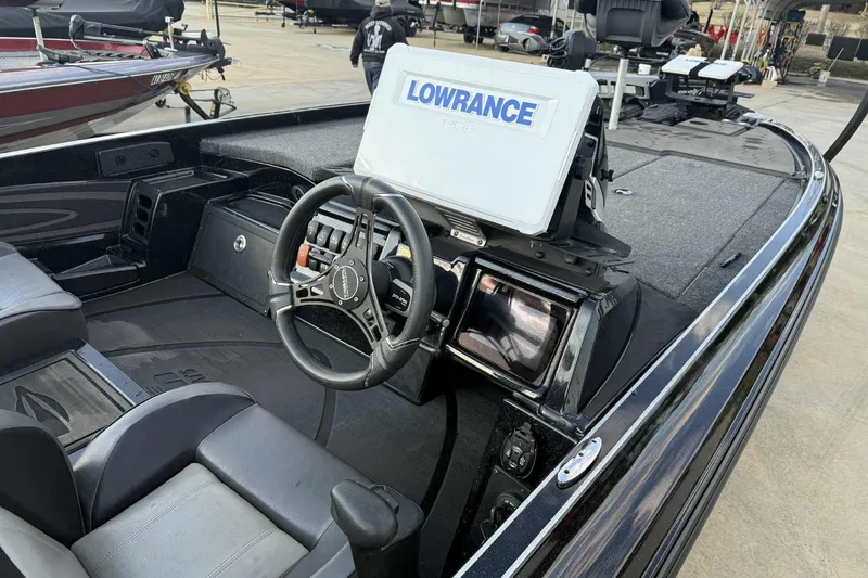 Slide: The Image of 2024 Triton 20XP Patriot boat interior with Lowrance HDS display and steering wheel. - 10