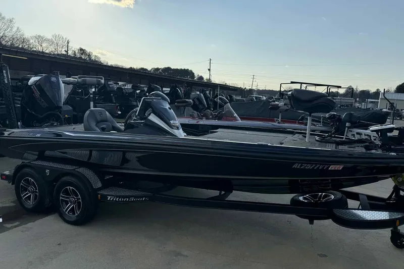 Slide: The Image of 2024 Triton 20XP Patriot boat on trailer, parked outdoors. - 12