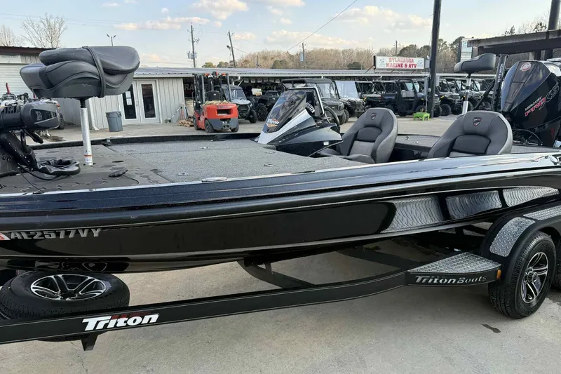 Slide: The Image of 2024 Triton 20XP Patriot boat on trailer, parked outdoors at a dealership. - 4