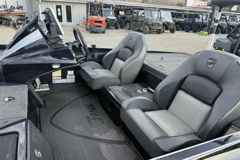 Slide: The Image of 2024 Triton 20XP Patriot boat interior with dual seats and steering console. - 5