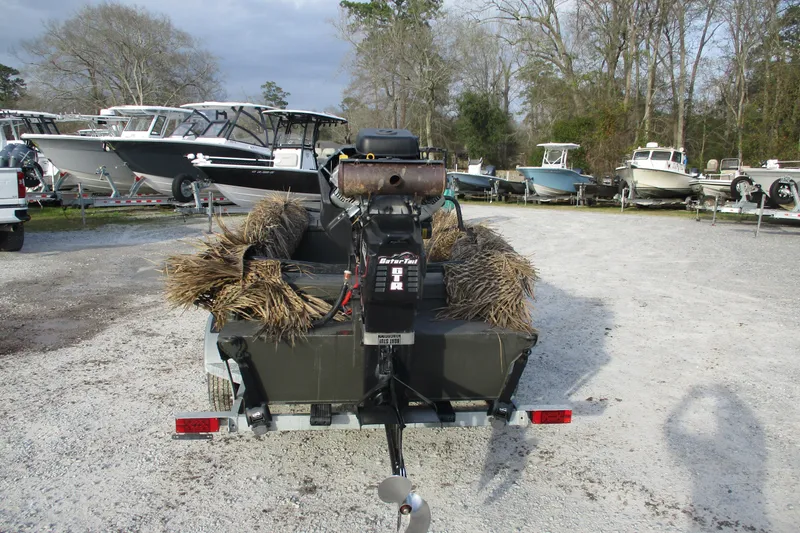 Slide: The Image of 2026 Gator Tail 1748 GATOR boat with camouflage, parked among other boats. - 4