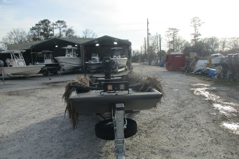 Slide: The Image of 2026 Gator Tail 1748 GATOR boat in outdoor storage, surrounded by other boats. - 5