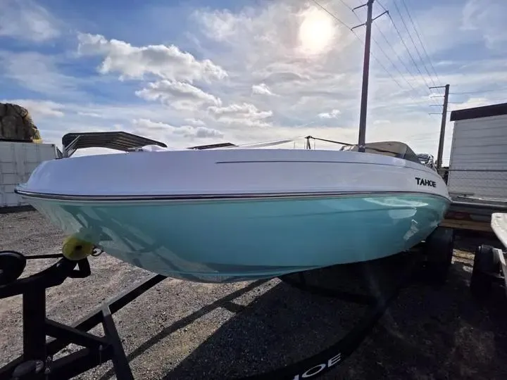 Slide: The Image of 2026 Tahoe T21 boat on trailer under sunny sky. - 3