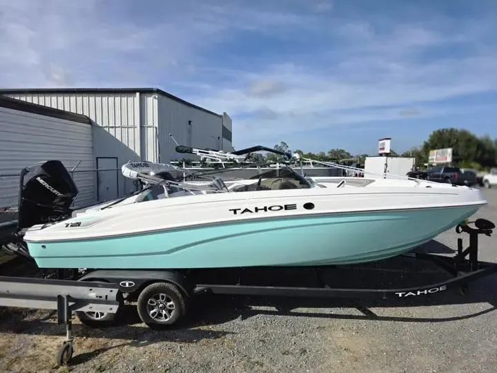 Slide: The Image of 2026 Tahoe T21 boat on trailer outside warehouse. - 8