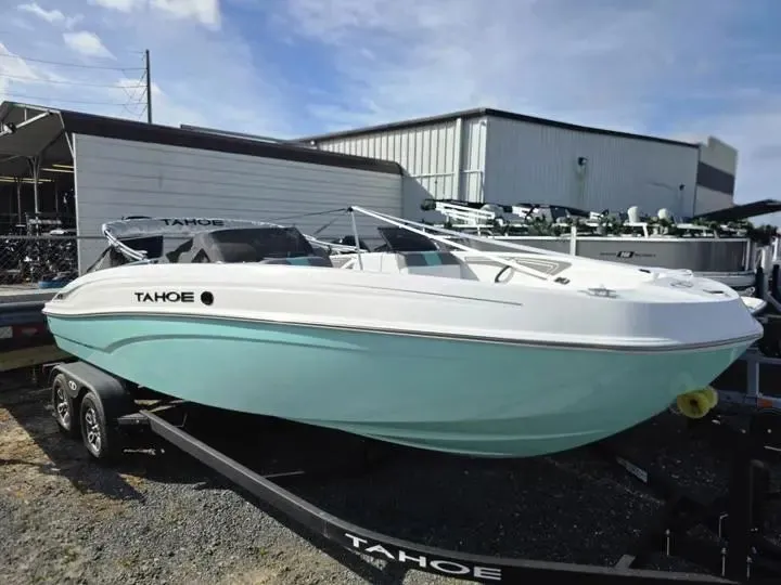Slide: The Image of 2026 Tahoe T21 boat on trailer in front of warehouse. - 9