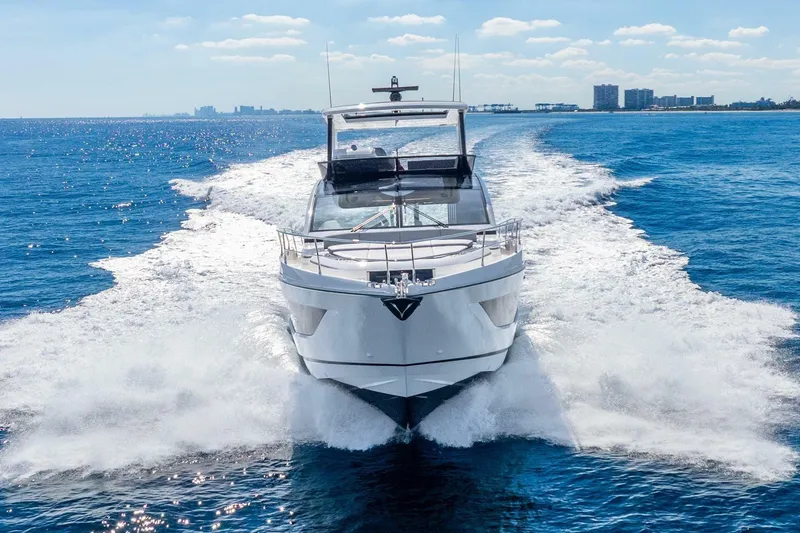 Slide: The Image of 2025 Pearl 63 yacht cruising on open blue ocean under clear sky. - 2