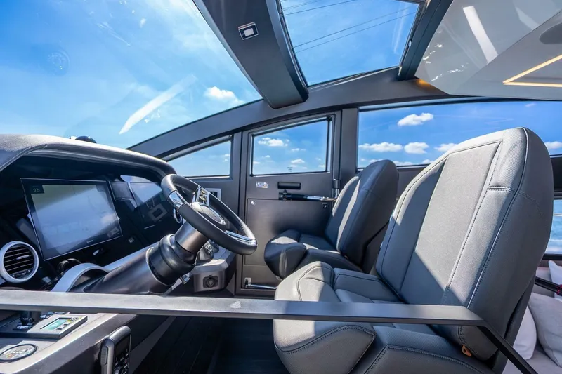 Slide: The Image of Interior of 2025 Pearl 63 yacht cockpit with modern steering and seating. - 26