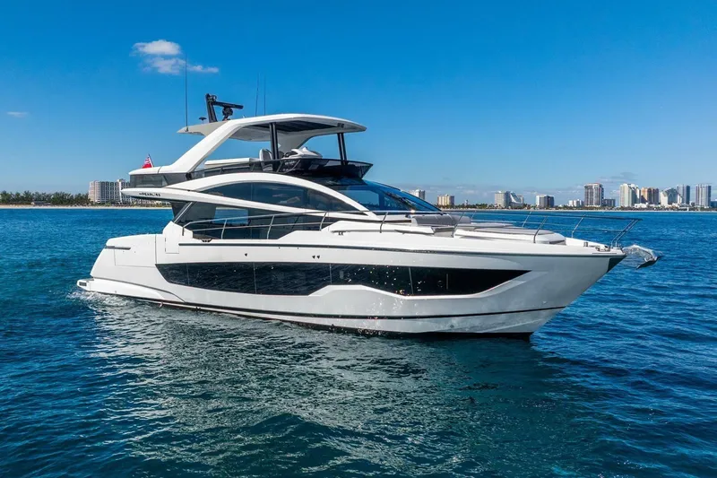 Slide: The Image of Luxury Pearl 63 yacht cruising on blue ocean, 2025 model, with city skyline in background. - 3