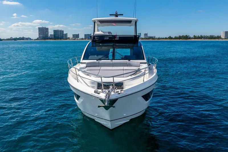 Slide: The Image of Front view of 2025 Pearl 63 yacht on blue ocean with city skyline. - 4