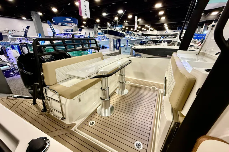 Slide: The Image of 2026 Zodiac X9CC boat interior with seating and table at a boat show. - 11