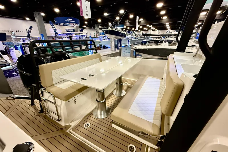 Slide: The Image of Zodiac X9CC 2026 boat interior with seating and table at a boat show. - 12