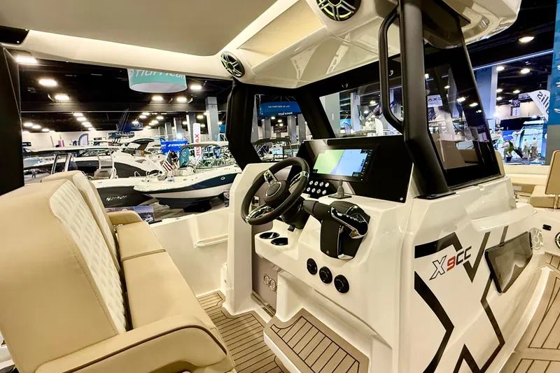 Slide: The Image of Interior view of 2026 Zodiac X9CC boat with modern dashboard and seating. - 14