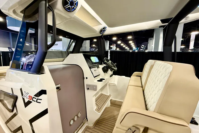 Slide: The Image of 2026 Zodiac X9CC boat interior with modern dashboard and beige seating. - 16