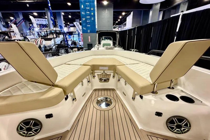 Slide: The Image of 2026 Zodiac X9CC boat interior with beige seating and modern design at a boat show. - 21