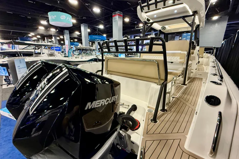 Slide: The Image of 2026 Zodiac X9CC boat with Mercury engines displayed at a boat show. - 5