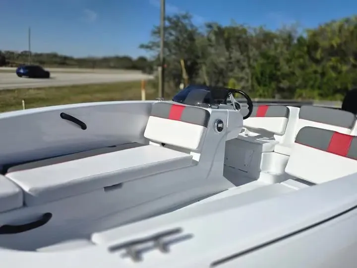 Slide: The Image of 2026 Tahoe T18 boat interior with white and red seating. - 13